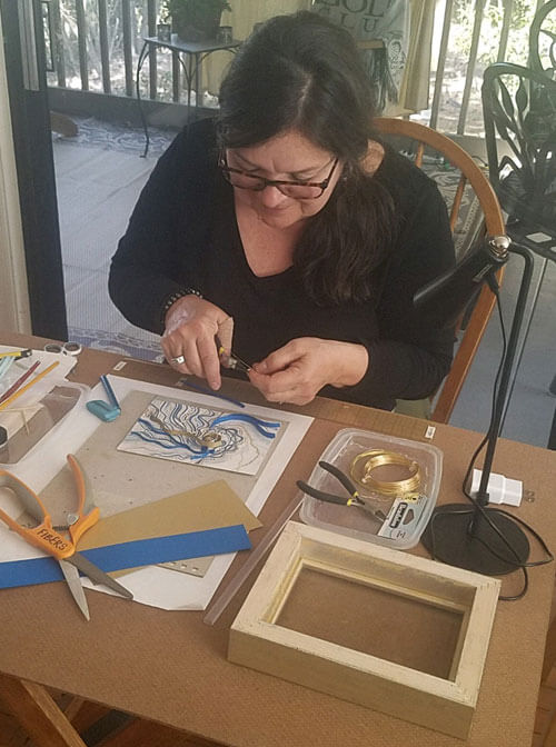 lisa working on mixed media piece